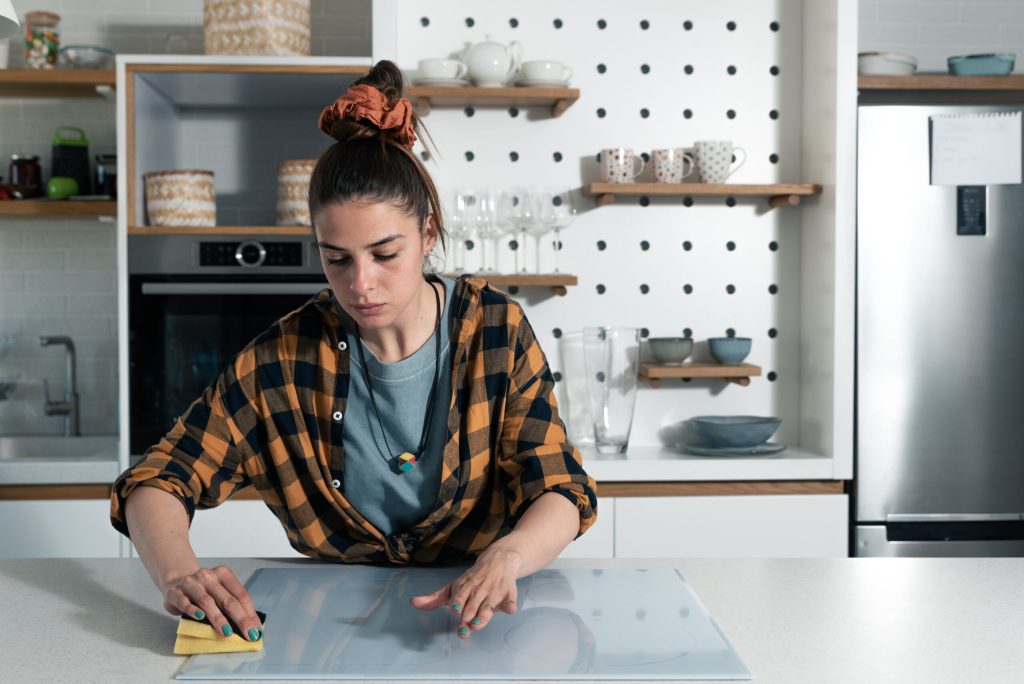 Young woman cleaning and struggling with OCD