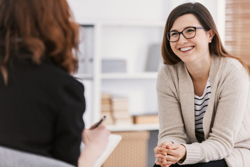 Growth-Oriented Psychotherapy: Developing Purpose and Missio Woman patient smiling while practicing growth oriented psychotherapy