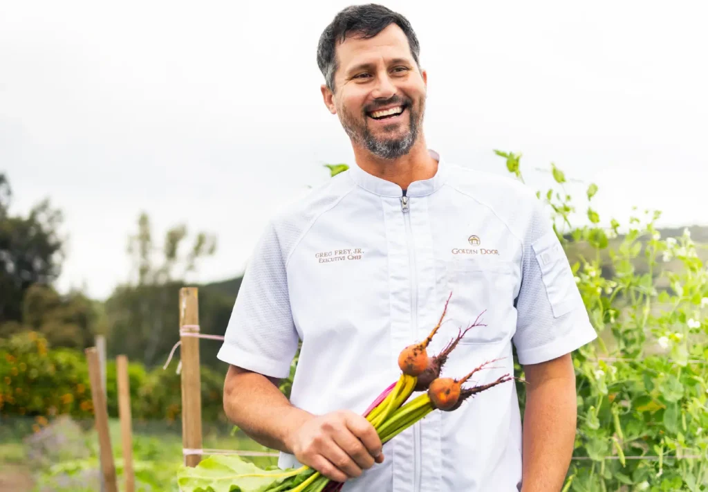 Golden Door Executive Chef Greg Frey Jr. holding freshly harvested beets in the garden
