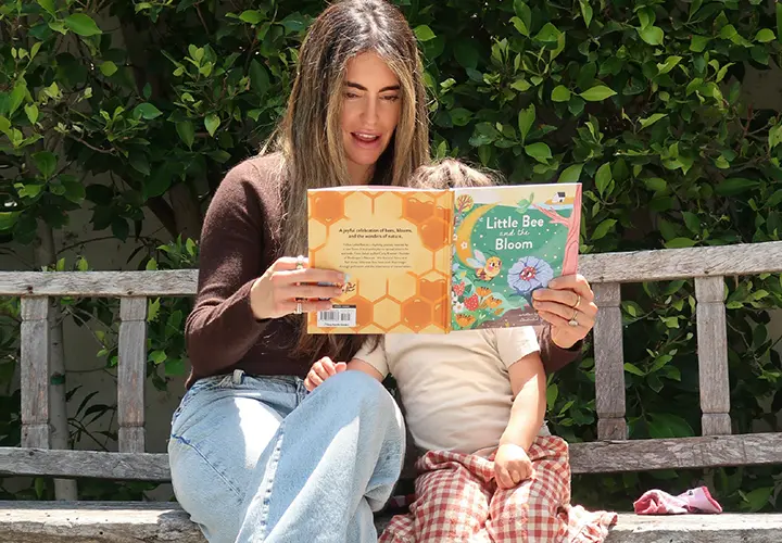 Raising Kids Who Care About Nature: Carly Kremer Carly Kremer reading a nature book with her child outdoors